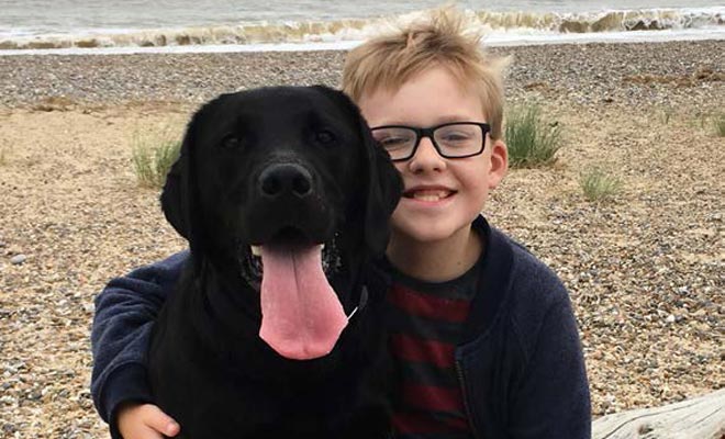 our client Daniel Jillings sat with his black lab at the beach